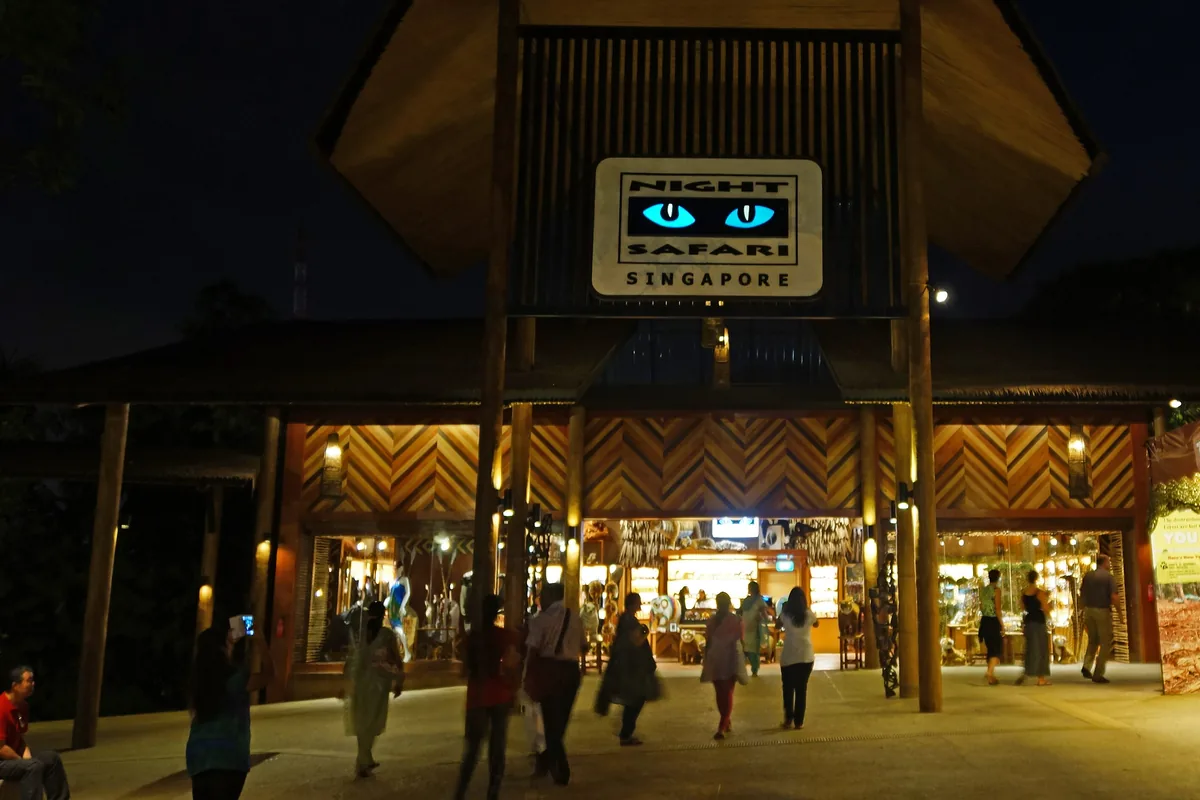 Η είσοδος του Night Safari με φωτισμένη στέγη περιπτέρου και έναν νυχτερινό ουρανό από πάνω